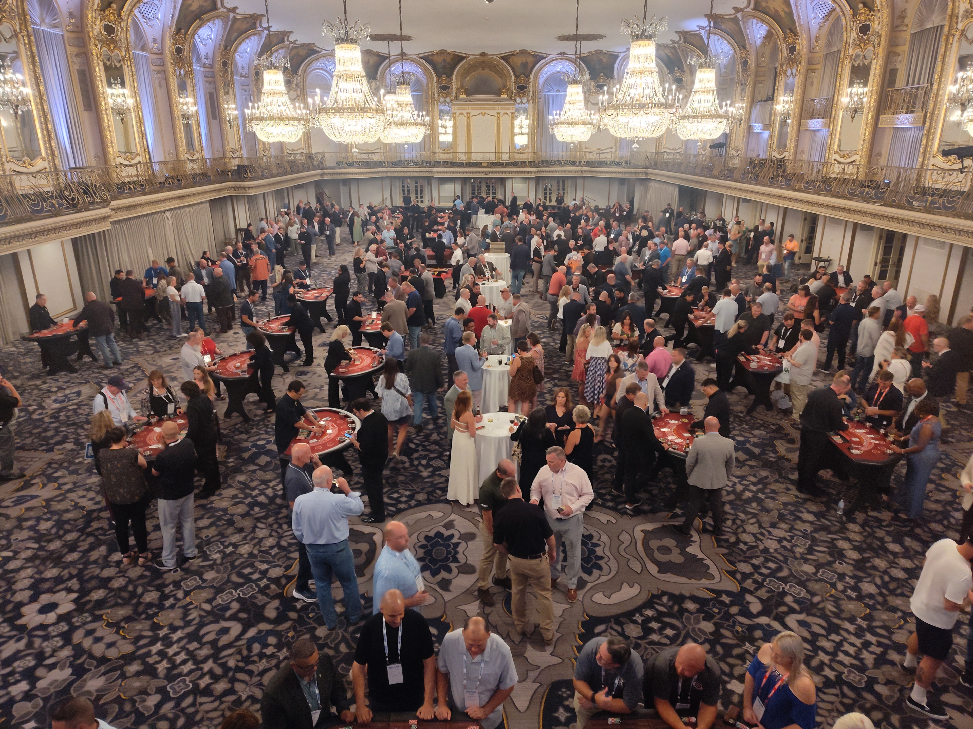 Casino event in a large ballroom with guests at gaming tables